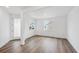 Bright, open-concept living room features luxury vinyl flooring, ample natural light, and neutral paint at 7016 E 126Th Pl, Thornton, CO 80602