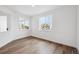 Inviting room featuring luxury vinyl flooring, large windows, and neutral paint at 7016 E 126Th Pl, Thornton, CO 80602