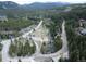 Overhead view of property and community with construction project nearby, surrounded by mature pine trees at 805 Columbine Rd # 105, Breckenridge, CO 80424