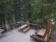 Enjoy outdoor dining on the spacious deck with a grill, picnic table, and serene forest views at 805 Columbine Rd # 105, Breckenridge, CO 80424