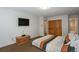 View of bedroom featuring a mounted TV, a wooden storage chest and a queen-sized bed with striped bedding at 805 Columbine Rd # 105, Breckenridge, CO 80424