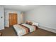 View of a well-lit bedroom featuring a queen bed with striped bedding and hardwood closet at 805 Columbine Rd # 105, Breckenridge, CO 80424