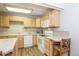 Well-lit kitchen features wood cabinets, white appliances, and ample counter space for meal preparation at 805 Columbine Rd # 105, Breckenridge, CO 80424