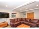 Comfortable living room with a large leather sectional sofa and a mounted television at 805 Columbine Rd # 105, Breckenridge, CO 80424