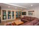 Bright living area features large windows, sliding doors, leather sofa, and a cozy fireplace at 805 Columbine Rd # 105, Breckenridge, CO 80424