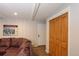 Cozy living room featuring a comfortable leather sofa and easy access to a hallway at 805 Columbine Rd # 105, Breckenridge, CO 80424