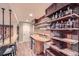 Basement bar with rustic shelving and a unique reclaimed wood feature wall at 24589 E Louisiana Cir, Aurora, CO 80018