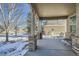 Covered porch with brick columns and seating, overlooking a residential street at 24589 E Louisiana Cir, Aurora, CO 80018