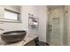 Modern bathroom featuring a vessel sink, granite countertop, and tiled shower with glass door at 11073 Newland St, Westminster, CO 80020