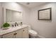 Bathroom with a vanity with a marble countertop, a toilet, and a framed picture on the wall at 11073 Newland St, Westminster, CO 80020