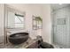 Modern bathroom featuring dark granite counters, vessel sink, and shower with white subway tile surround at 11073 Newland St, Westminster, CO 80020