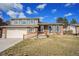 Charming two-story home with brick accents, green shutters, landscaped lawn, and driveway at 11073 Newland St, Westminster, CO 80020