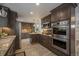 Modern kitchen with stainless steel appliances, granite countertops, and ample cabinet space at 11073 Newland St, Westminster, CO 80020