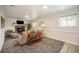 Spacious living room with a carpeted floor, fireplace, and multiple windows at 11073 Newland St, Westminster, CO 80020