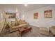 Spacious living room with a carpeted floor, and a view of the upstairs living area at 11073 Newland St, Westminster, CO 80020