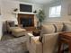 Cozy living space with a brick fireplace, comfortable seating, and neutral decor at 11073 Newland St, Westminster, CO 80020