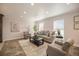 Bright living room with neutral decor, tile flooring, and large windows at 11073 Newland St, Westminster, CO 80020