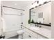 Stylish bathroom featuring a soaking tub, white vanity with granite countertop, and updated fixtures at 7453 E Jefferson Dr, Denver, CO 80237