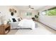Bright bedroom with a ceiling fan, natural light, and decorative accents. The bed is neatly made and inviting at 7453 E Jefferson Dr, Denver, CO 80237
