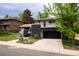 Home exterior with dark brick accents and attached garage at 7453 E Jefferson Dr, Denver, CO 80237