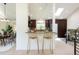 View of updated kitchen with breakfast bar seating and modern finishes, plus adjacent living area at 7453 E Jefferson Dr, Denver, CO 80237