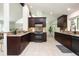 Spacious kitchen featuring granite countertops, dark wood cabinetry and modern stainless steel appliances at 7453 E Jefferson Dr, Denver, CO 80237