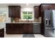 Modern kitchen boasts dark cabinets, stainless steel appliances, and a bright window view at 7453 E Jefferson Dr, Denver, CO 80237