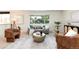 Bright living room with stylish furniture, natural light, and views of the front yard at 7453 E Jefferson Dr, Denver, CO 80237