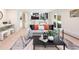 Open-concept living room features modern furniture, black metal railings, and contemporary decor at 7453 E Jefferson Dr, Denver, CO 80237