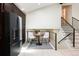 Charming sitting area with black railing, high ceilings and natural light near the staircase at 7453 E Jefferson Dr, Denver, CO 80237