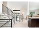 Modern staircase features light wood stairs, contrasting black metal railings, and an open floor plan at 7453 E Jefferson Dr, Denver, CO 80237