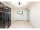 Large walk-in closet with modern glass door cabinets and ample storage space at 7453 E Jefferson Dr, Denver, CO 80237