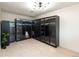 Large walk-in closet with modern glass door cabinets and ample storage space at 7453 E Jefferson Dr, Denver, CO 80237