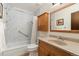 Bathroom features a tub/shower combo with marble-like tiling, and a wooden vanity with ample storage at 11936 W Temple Dr, Morrison, CO 80465