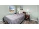 Comfortable bedroom featuring wood laminate floors, and view of outside scenery through bright window at 11936 W Temple Dr, Morrison, CO 80465