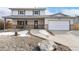 Charming two-story home boasts a covered porch, updated garage door and rock landscaping at 11936 W Temple Dr, Morrison, CO 80465