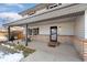 Inviting front porch features exposed brick detail, seating and a welcome mat at 11936 W Temple Dr, Morrison, CO 80465