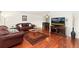 Spacious living room features gleaming hardwood floors and adjoins the dining area at 11936 W Temple Dr, Morrison, CO 80465