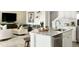 Bright kitchen with stainless steel appliances and white cabinetry is open to a stylish and comfortable living space at 13342 Blue Amber Ct, Parker, CO 80134