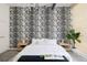 Bright bedroom with black and white wallpaper, light hardwood floors, and modern lighting fixtures at 1467 Delgany St # 1, Denver, CO 80202