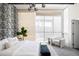 Bright bedroom with a black and white wallpaper, light hardwood floors, and modern chair by the window at 1467 Delgany St # 1, Denver, CO 80202