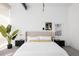 Modern bedroom with neutral tones, sleek black nightstands and a bright window at 1467 Delgany St # 1, Denver, CO 80202