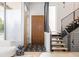Modern entryway with sleek stairs, storage, and stylish black and white tile at 1467 Delgany St # 1, Denver, CO 80202