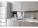 Modern kitchen with stainless steel appliances, neutral cabinets, countertop decor, and unique faucet at 1467 Delgany St # 1, Denver, CO 80202