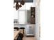 Close up of a modern kitchen bar with gray cabinets, a mini fridge and unique stools at 1467 Delgany St # 1, Denver, CO 80202