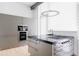 Kitchen area showcasing stainless steel appliances, stylish cabinetry, large window, and a central island with cooktop at 1467 Delgany St # 1, Denver, CO 80202