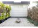 Private patio with modern fire pit, stone pavers, and green foliage, creating a tranquil outdoor space at 1467 Delgany St # 1, Denver, CO 80202