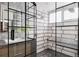 Modern bathroom with a spacious shower featuring black trim and a tiled bench at 1467 Delgany St # 1, Denver, CO 80202