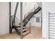 Modern staircase with wood treads and metal railings leads to the upper level of the home at 1467 Delgany St # 1, Denver, CO 80202