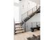 Modern staircase with metal railings, wooden steps, and unique lighting, creating an open and airy ambiance at 1467 Delgany St # 1, Denver, CO 80202